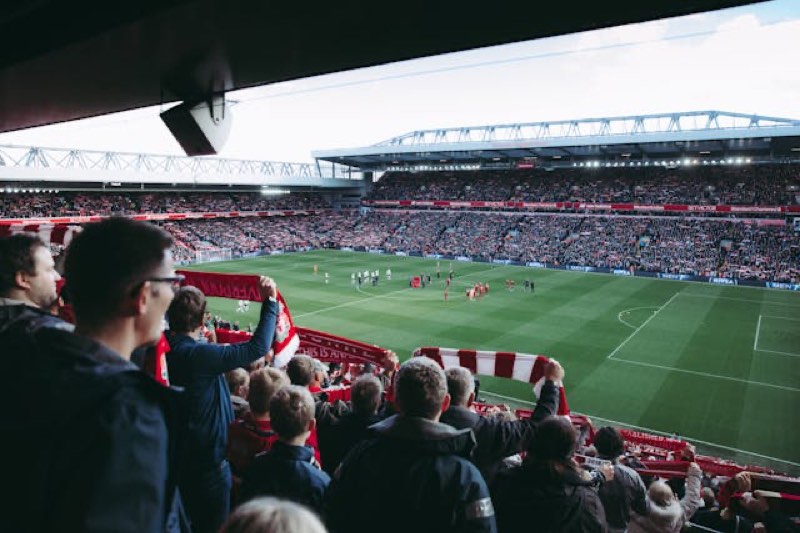 Floodlit stadium filled with fans on matchday
